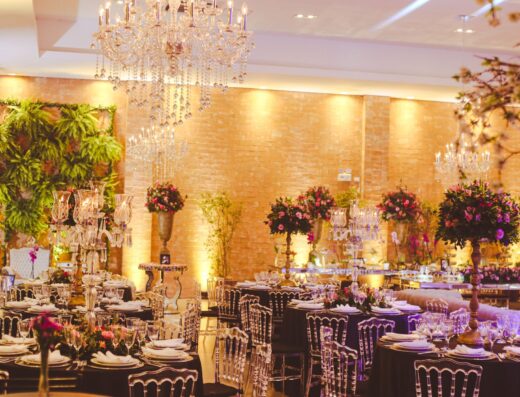 Montaje de recepción de boda lujoso que incluye candelabros, arreglos florales y elegantes mesas.