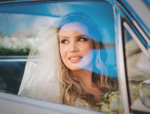 Una novia alegre mira desde la ventanilla de un automóvil en Asunción, Paraguay.