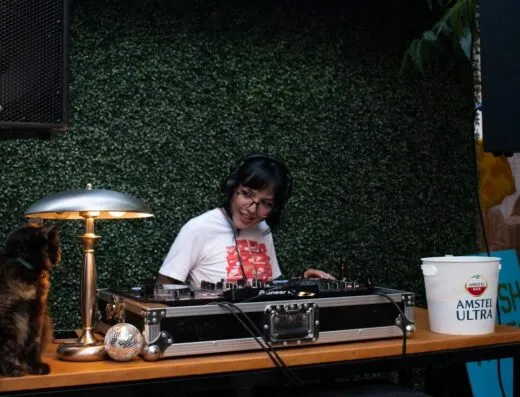 DJ tocando música en un evento al aire libre en Saltillo, México. Ambiente nocturno vibrante.