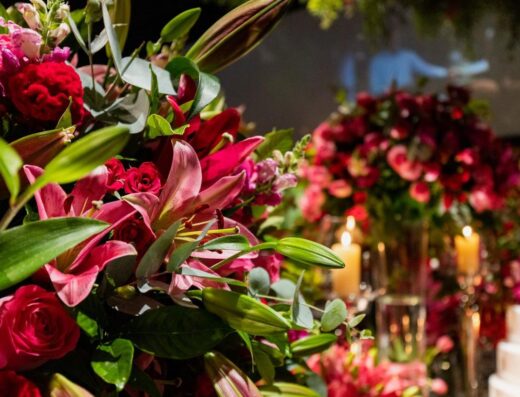 Lujoso arreglo floral con flores rosas vibrantes en un evento sofisticado.